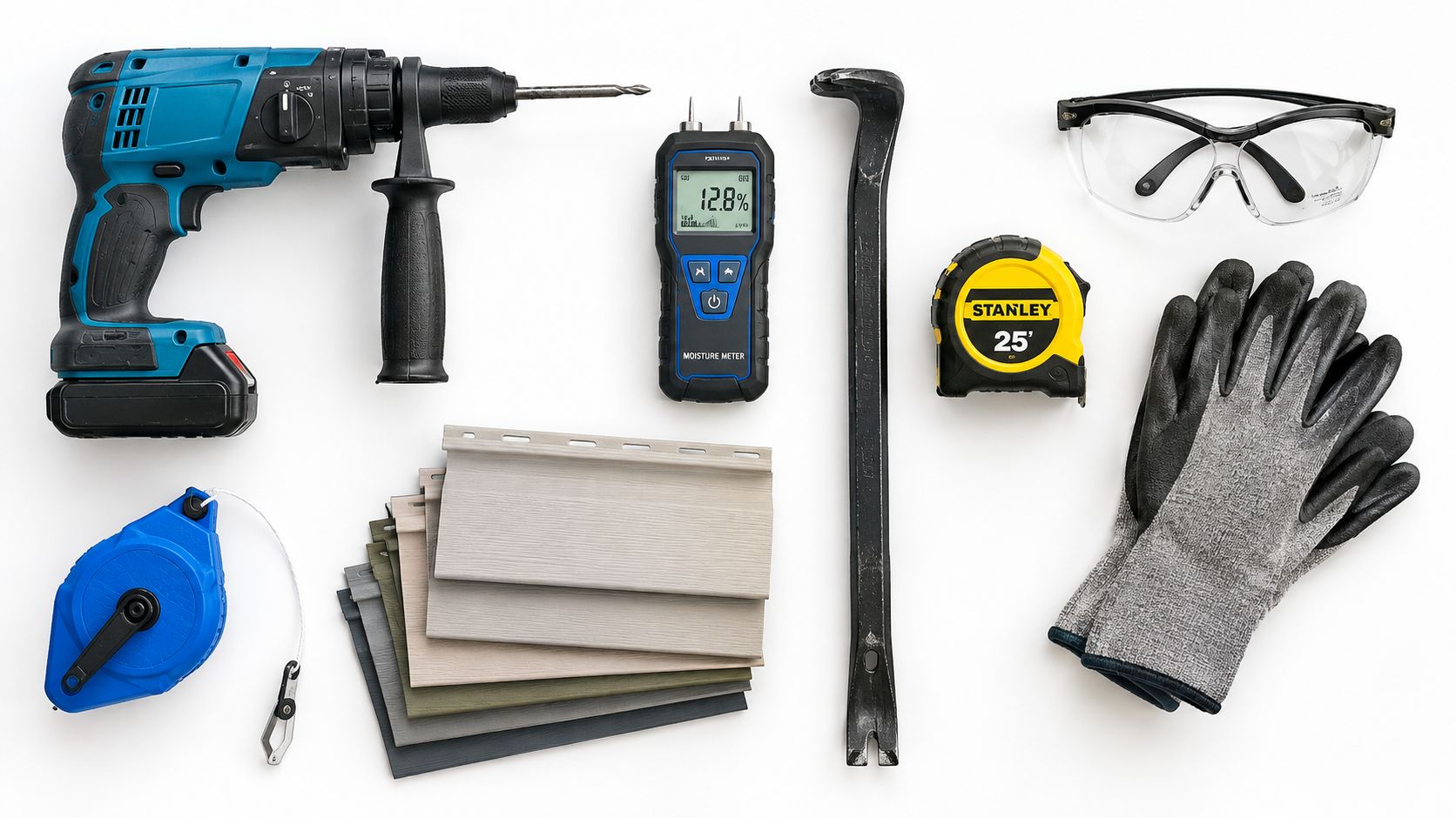 An overhead flat lay shot of home renovation tools including a drill, siding samples, moisture meter, and gloves.